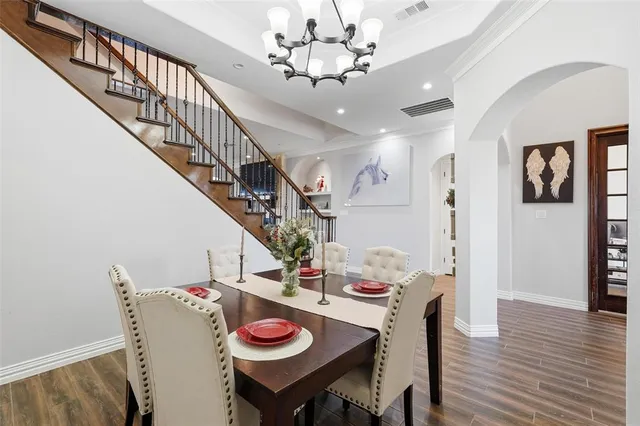 a view of livingroom and dining room with furniture wooden floor and a chandelier