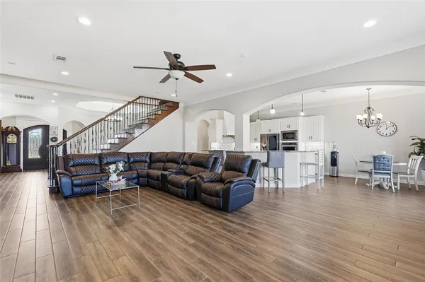 a living room with furniture and wooden floor