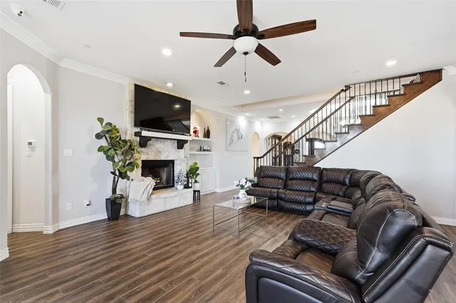 a living room with furniture or wooden floor and a fireplace