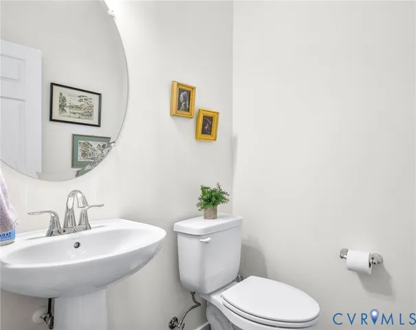 a bathroom with a sink mirror and toilet