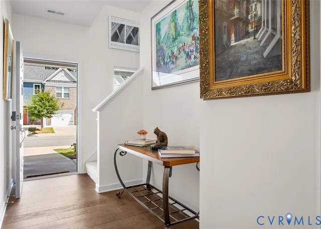 a living room with furniture and a painting on the wall