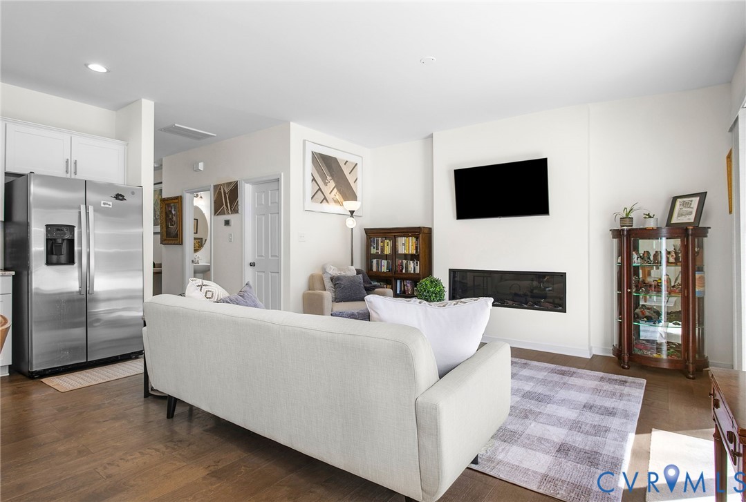 6549 Bolles Landing Court Chester, VA 23831 - Photo 7 of 22 a living room with furniture a flat screen tv and a fireplace