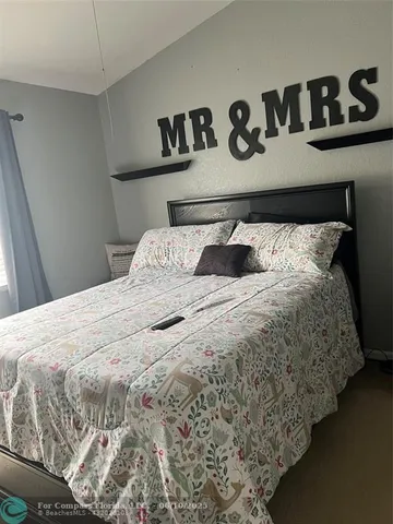 a view of walk in closet with clothes