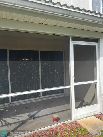 a front view of a house with garden and patio