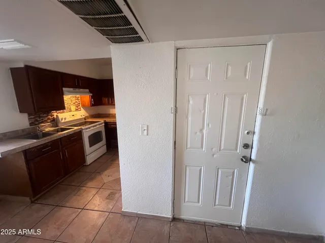 a kitchen with stainless steel appliances granite countertop a stove and a sink