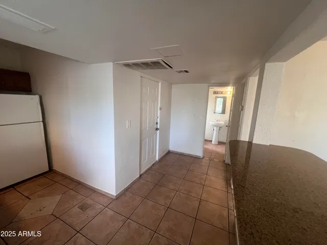 a kitchen with a refrigerator and a sink