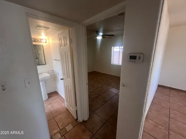 a view of a livingroom with a ceiling fan and window