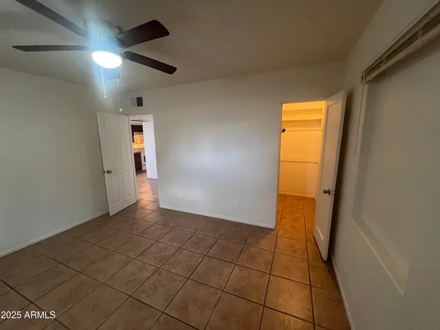 a view of a livingroom with an empty space and a window