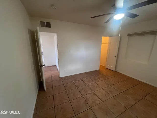 a view of a room with a refrigerator and a window