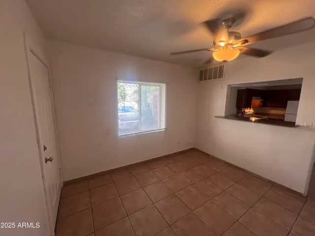 an empty room with windows and fireplace