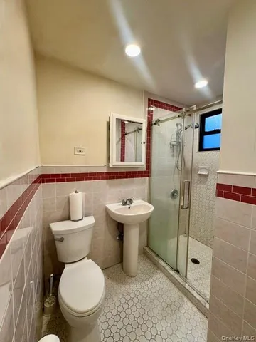 a bathroom with a toilet sink and shower