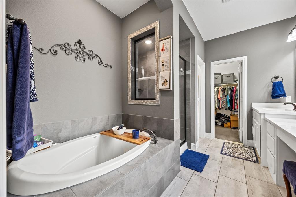 813 Pier Street Little Elm, TX 76227 - Photo 10 of 16 a bath tub sitting next to a bathroom sink