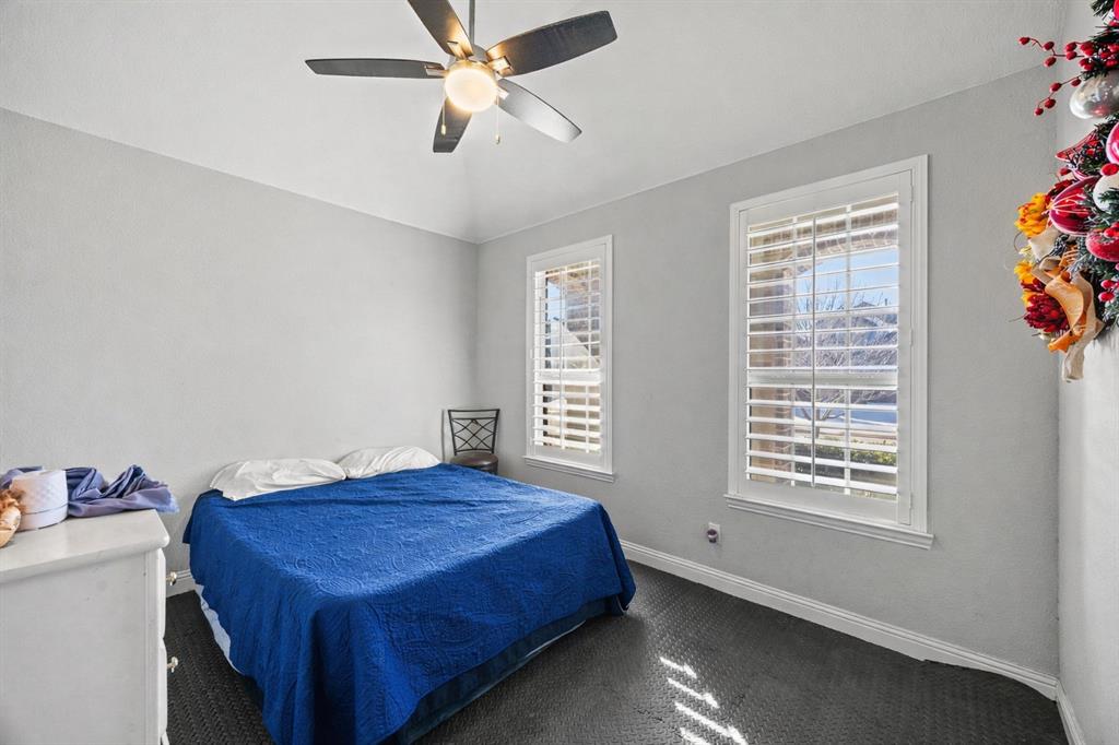 813 Pier Street Little Elm, TX 76227 - Photo 11 of 16 a bedroom with a bed and a window