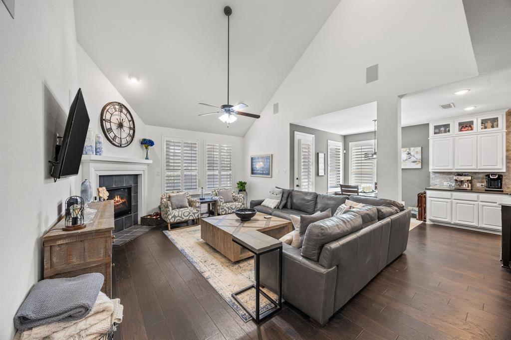 813 Pier Street Little Elm, TX 76227 - Photo 2 of 16 a living room with fireplace furniture and a wooden floor
