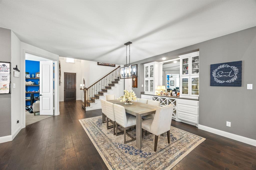 813 Pier Street Little Elm, TX 76227 - Photo 3 of 16 a dining room with wooden floor and a rug