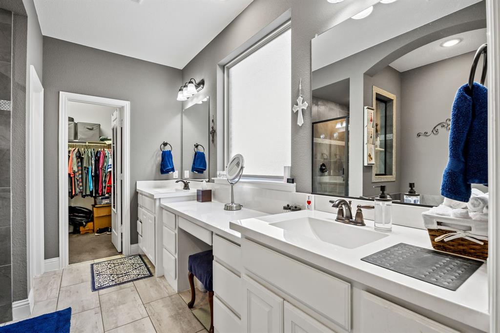 813 Pier Street Little Elm, TX 76227 - Photo 9 of 16 a en suite bathroom with double vanity and a mirror