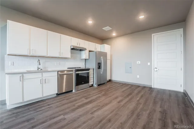 a kitchen with a sink and steel stainless steel appliances