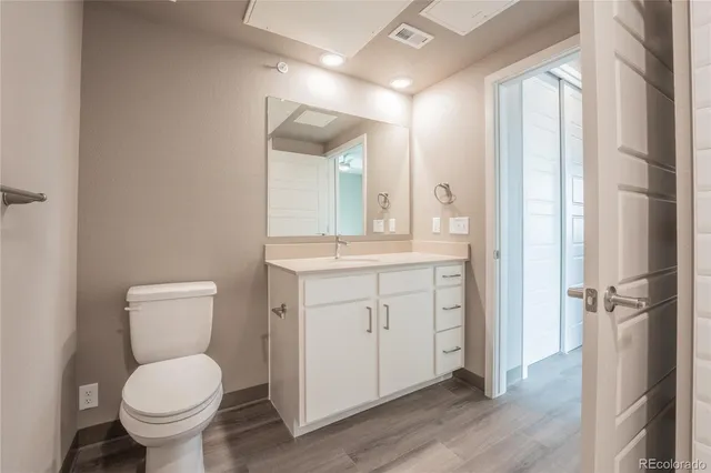 a bathroom with a toilet sink and a mirror