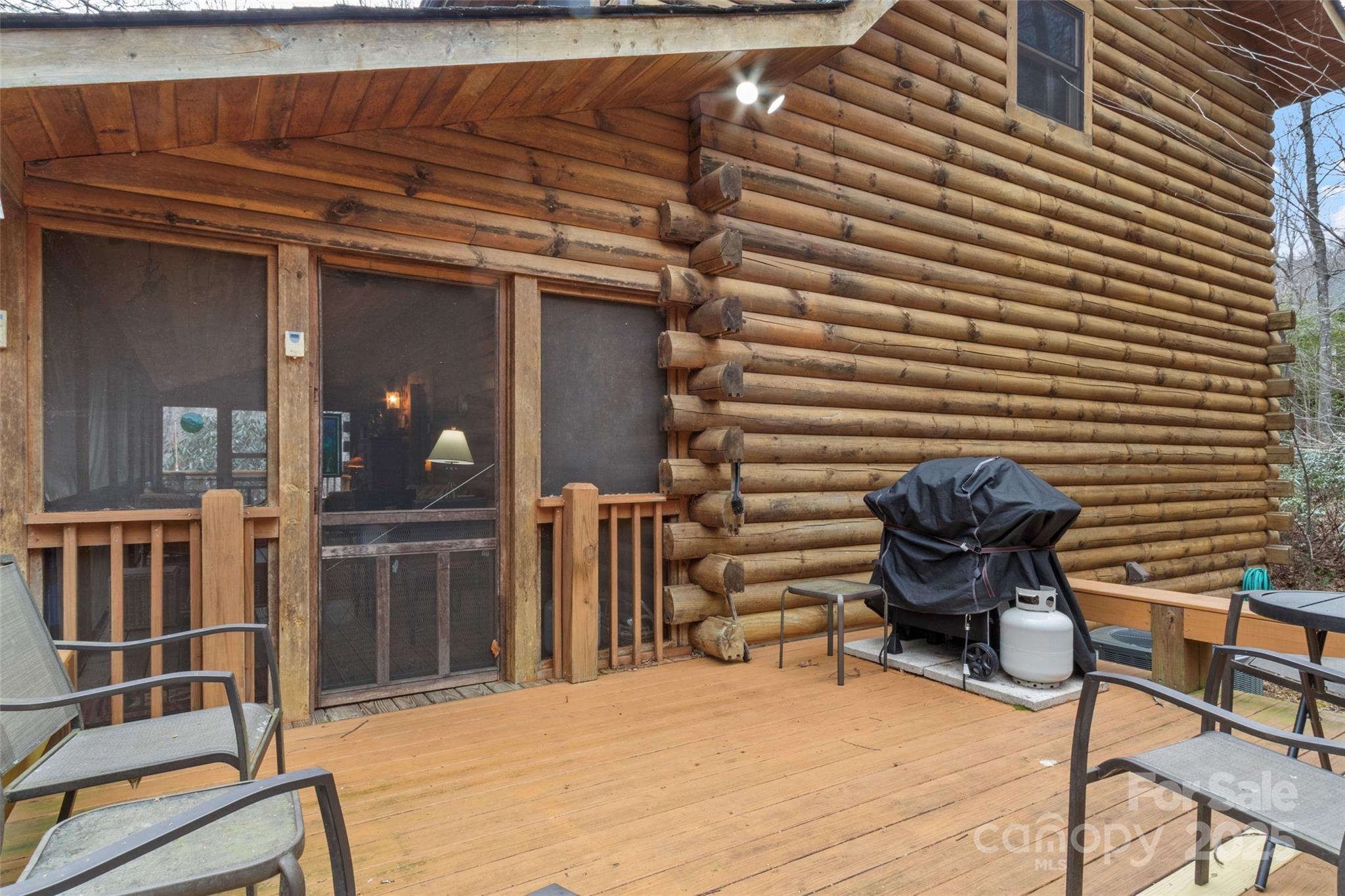 741 South Toe River Road Burnsville, NC 28714 - Photo 12 of 41 a view of a chair and tables in the patio