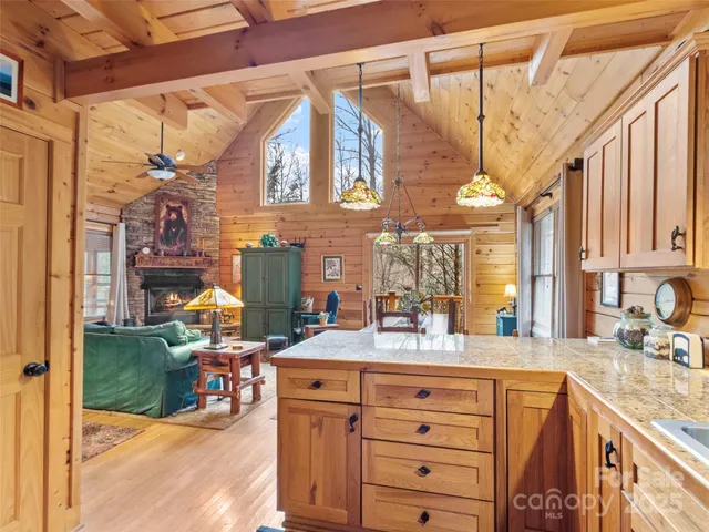 a bathroom with a sink vanity granite tub shower and a mirror
