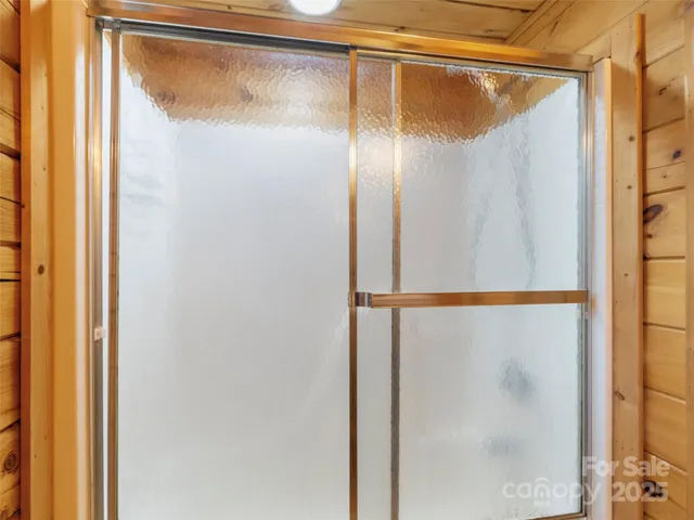 a bathroom with a glass shower door
