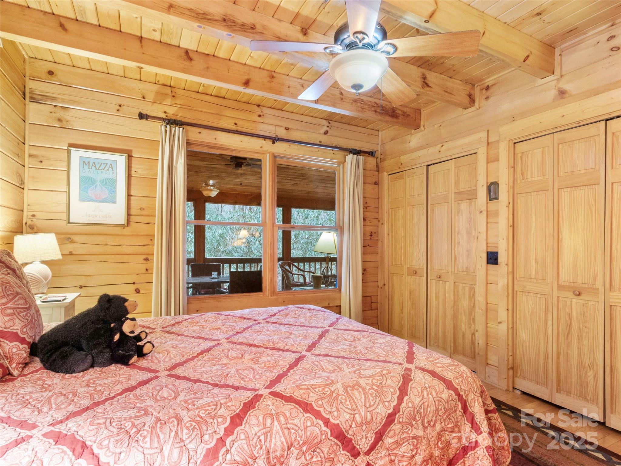 741 South Toe River Road Burnsville, NC 28714 - Photo 25 of 41 a large bedroom with a bed and a large window