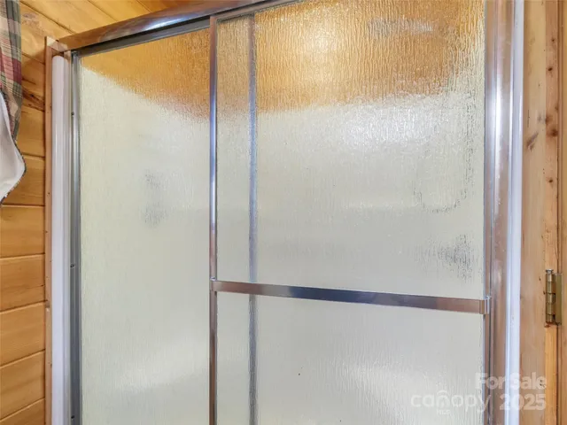 a bathroom with a glass shower door