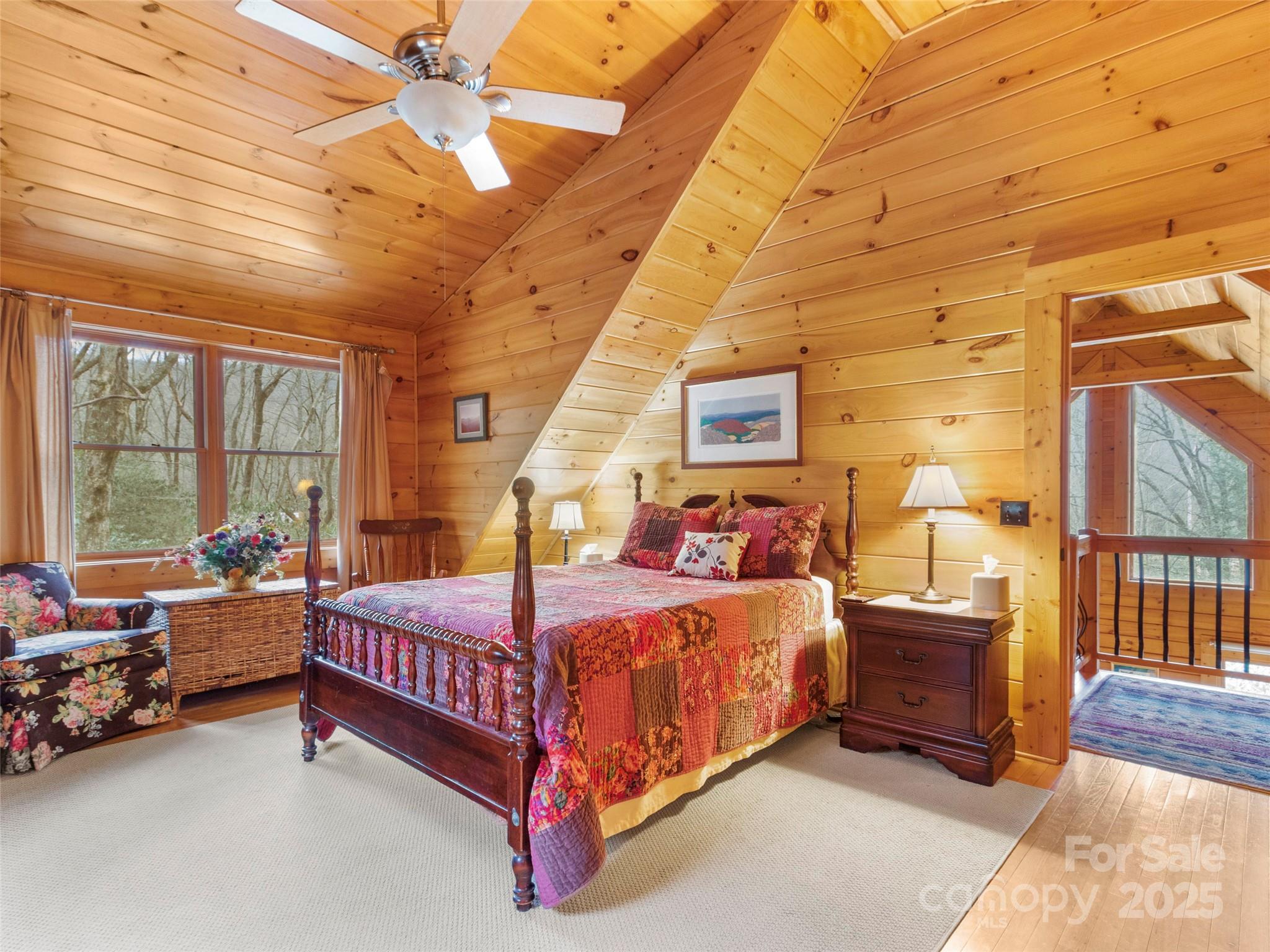 741 South Toe River Road Burnsville, NC 28714 - Photo 32 of 41 a bedroom with a bed couch and a table