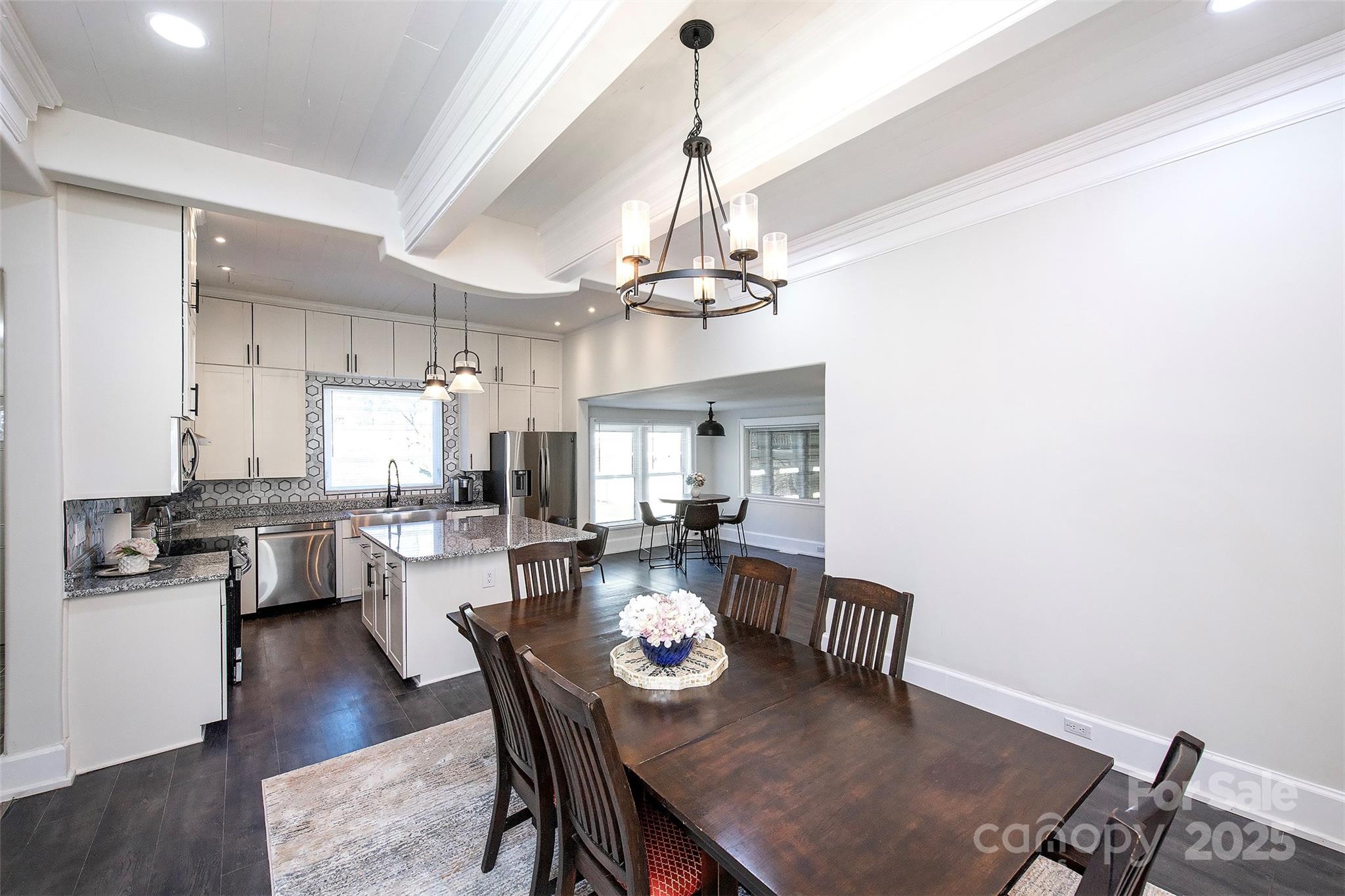 1615 Stack Road Monroe, NC 28112 - Photo 18 of 43 a dining room with wooden floor a chandelier a wooden table and chairs