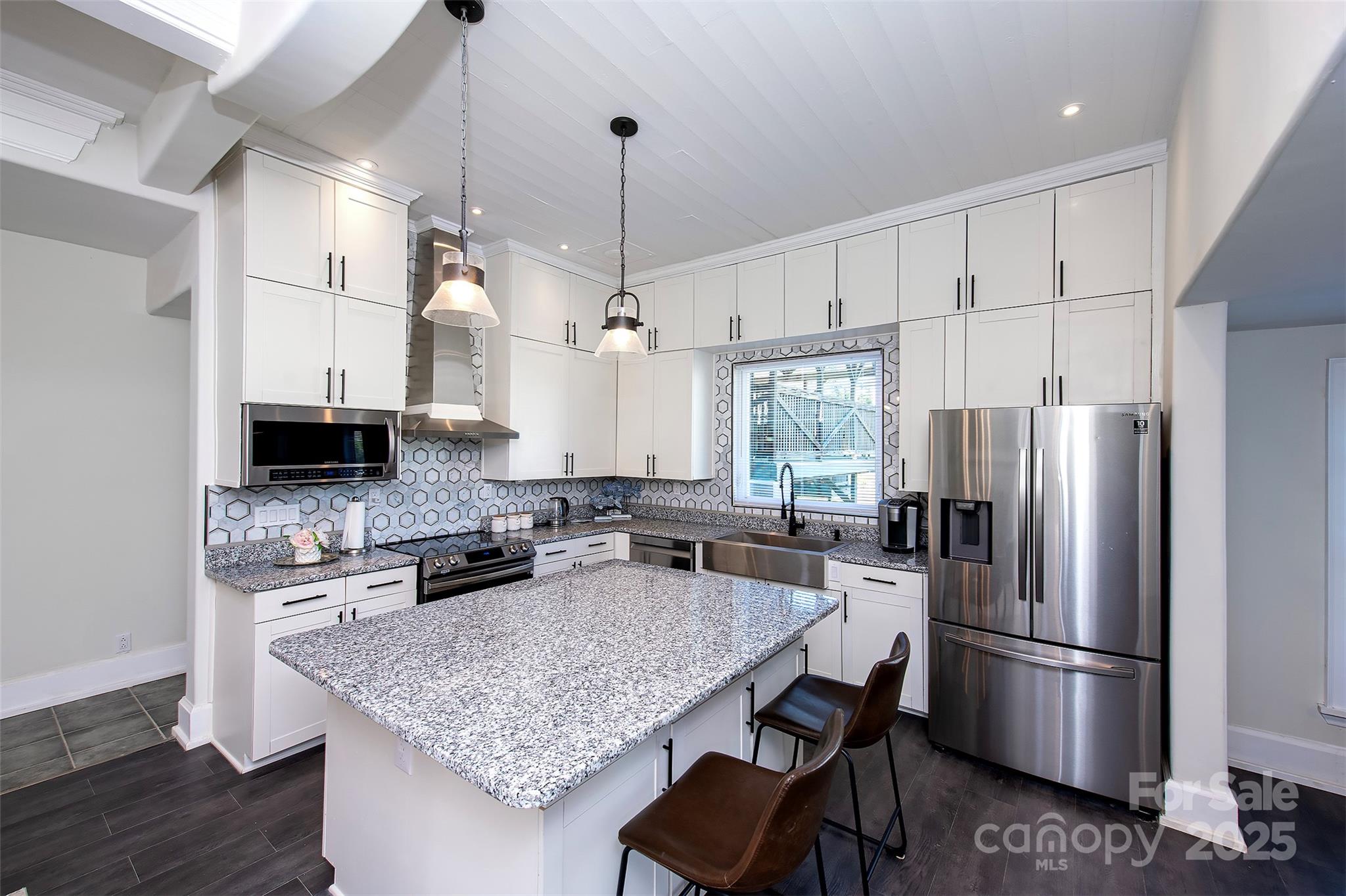 1615 Stack Road Monroe, NC 28112 - Photo 20 of 43 a kitchen with refrigerator a stove a center island and a wooden floor