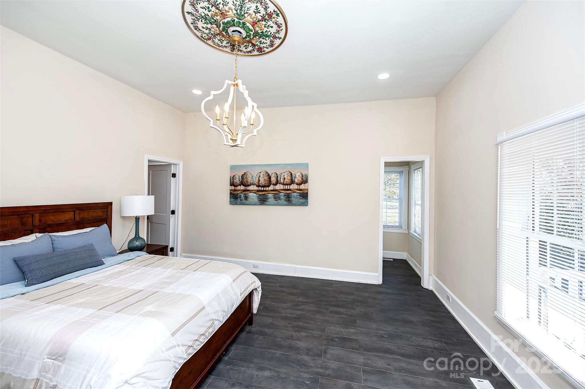 1615 Stack Road Monroe, NC 28112 - Photo 6 of 43 a bedroom with a large bed and a chandelier