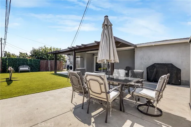a view of a patio with a table and chairs