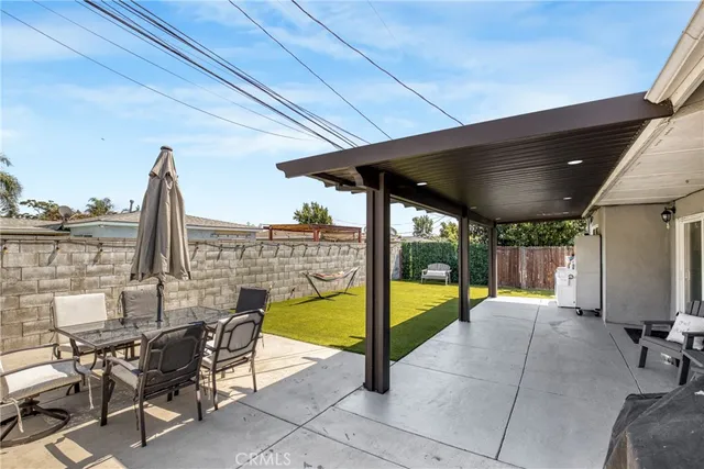 a view of a patio with a table and chairs