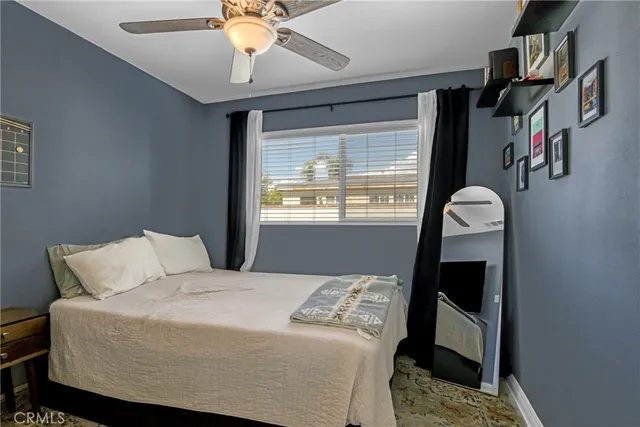 a bedroom with a bed and a window