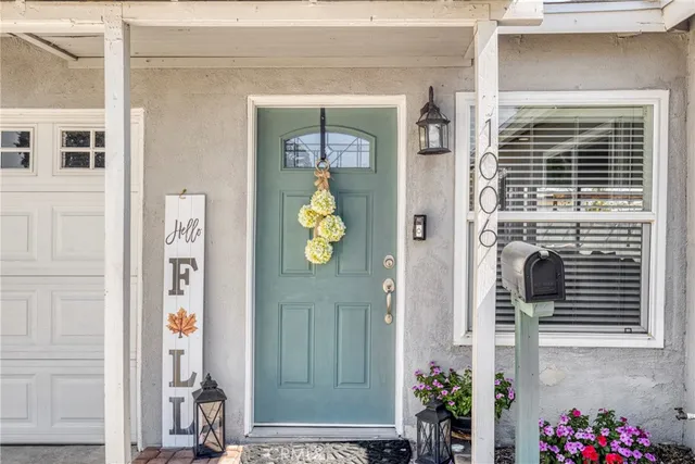 a front view of a house with a potted plant and windows