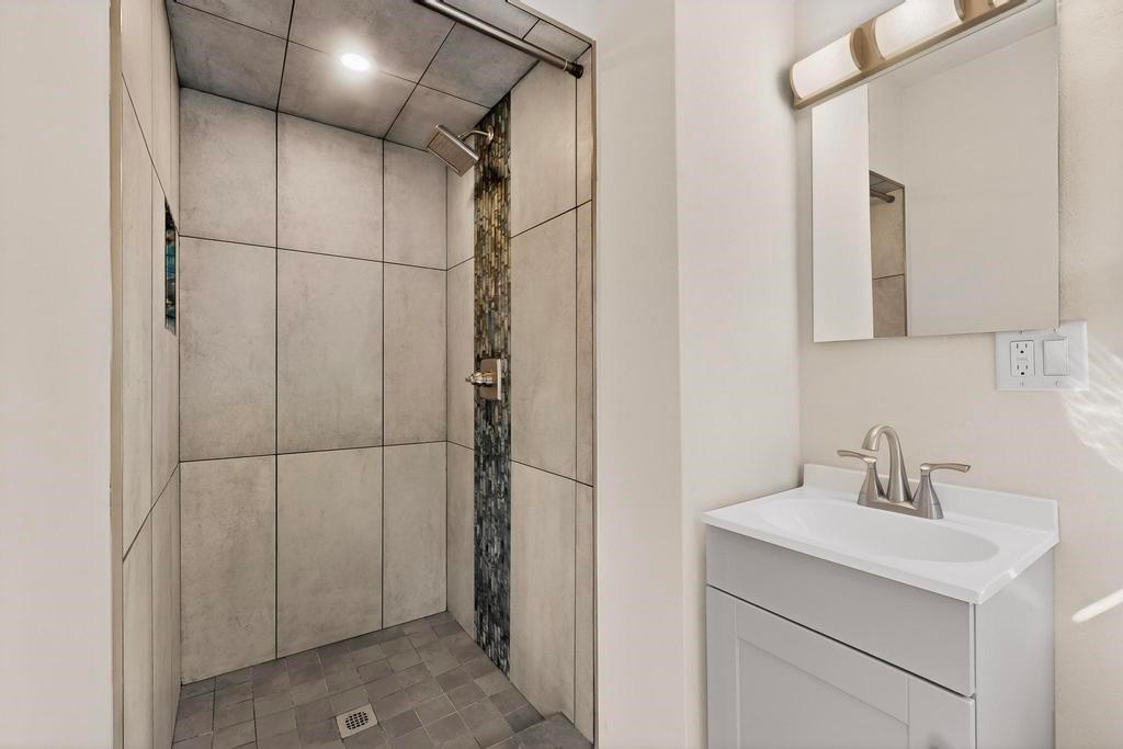 2120 Healey Drive Dallas, TX 75228 - Photo 31 of 39 a bathroom with a sink and a mirror