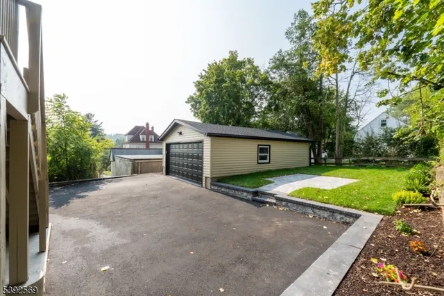 a front view of house with yard and trees