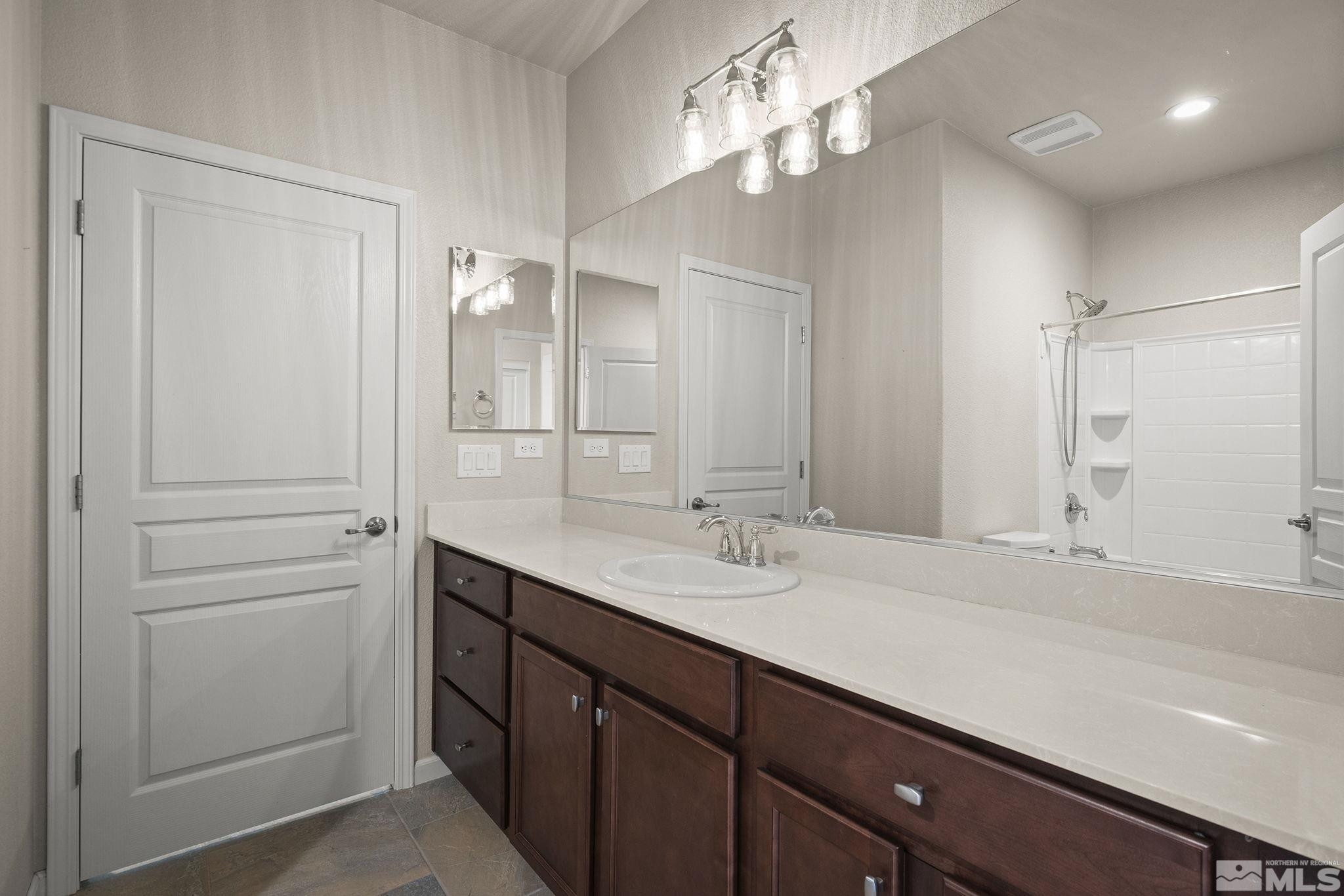 966 Callaway Trail Reno, NV 89523 - Photo 12 of 33 a bathroom with a double vanity sink and a mirror