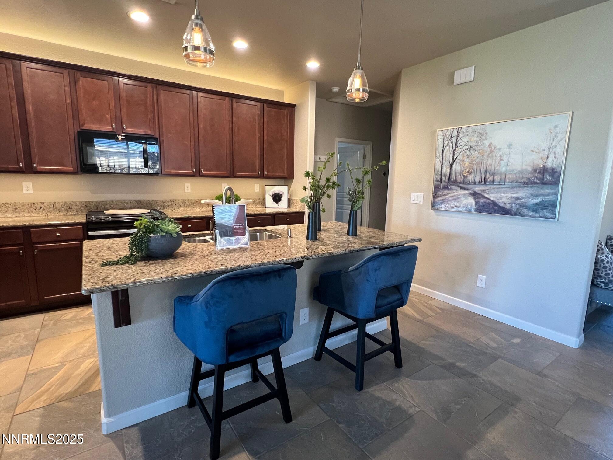 966 Callaway Trail Reno, NV 89523 - Photo 5 of 33 a kitchen with a cabinets appliances and a dining table