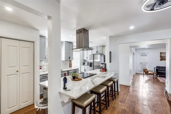 a view of a dining room with furniture and wooden floor