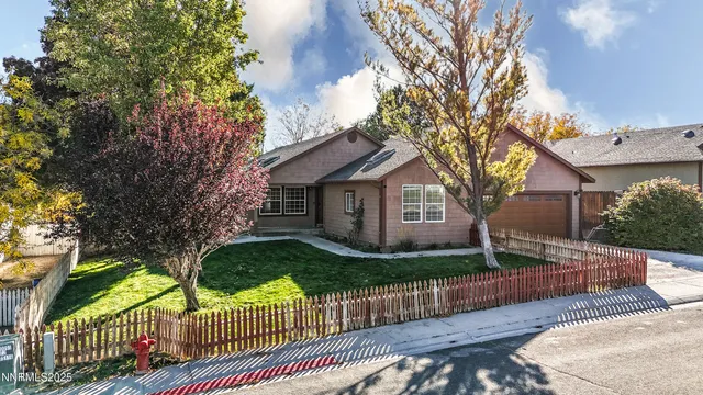 a front view of house with yard and trees
