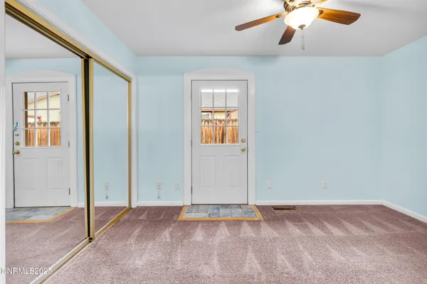an empty room with closet and chandelier fan