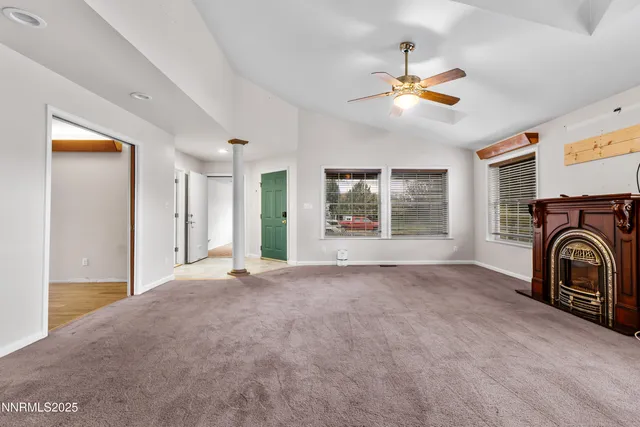 a view of a livingroom with a ceiling fan and a window