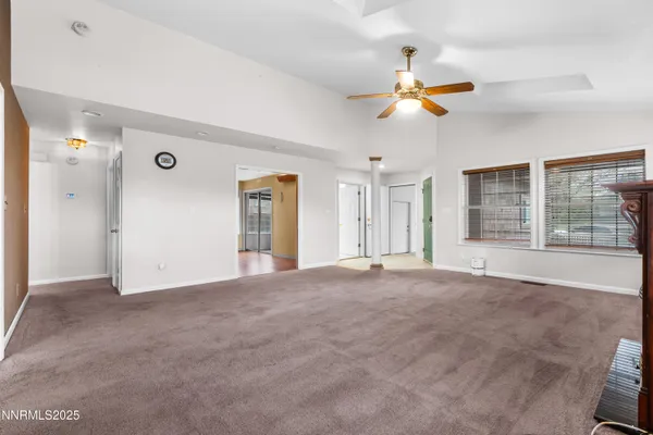 a view of an empty room with window and cabinet