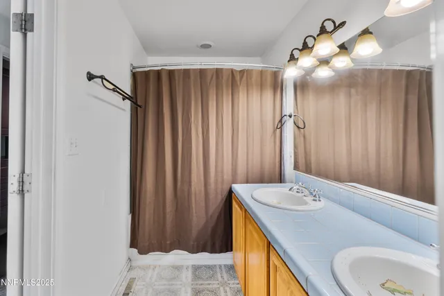 a bathroom with a sink vanity and a mirror