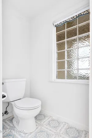 a white toilet sitting next to a window