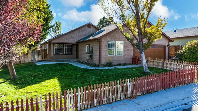 a front view of house with yard and green space