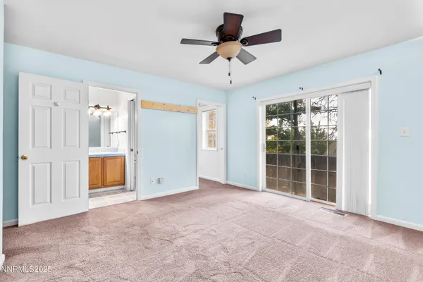 an empty room with windows & cabinet area