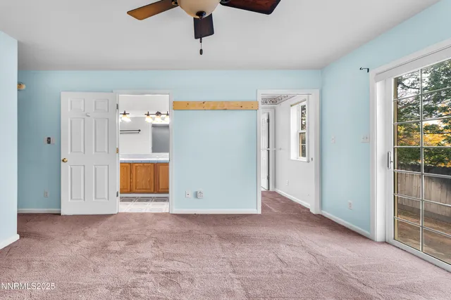 a view of an empty room with a ceiling fan