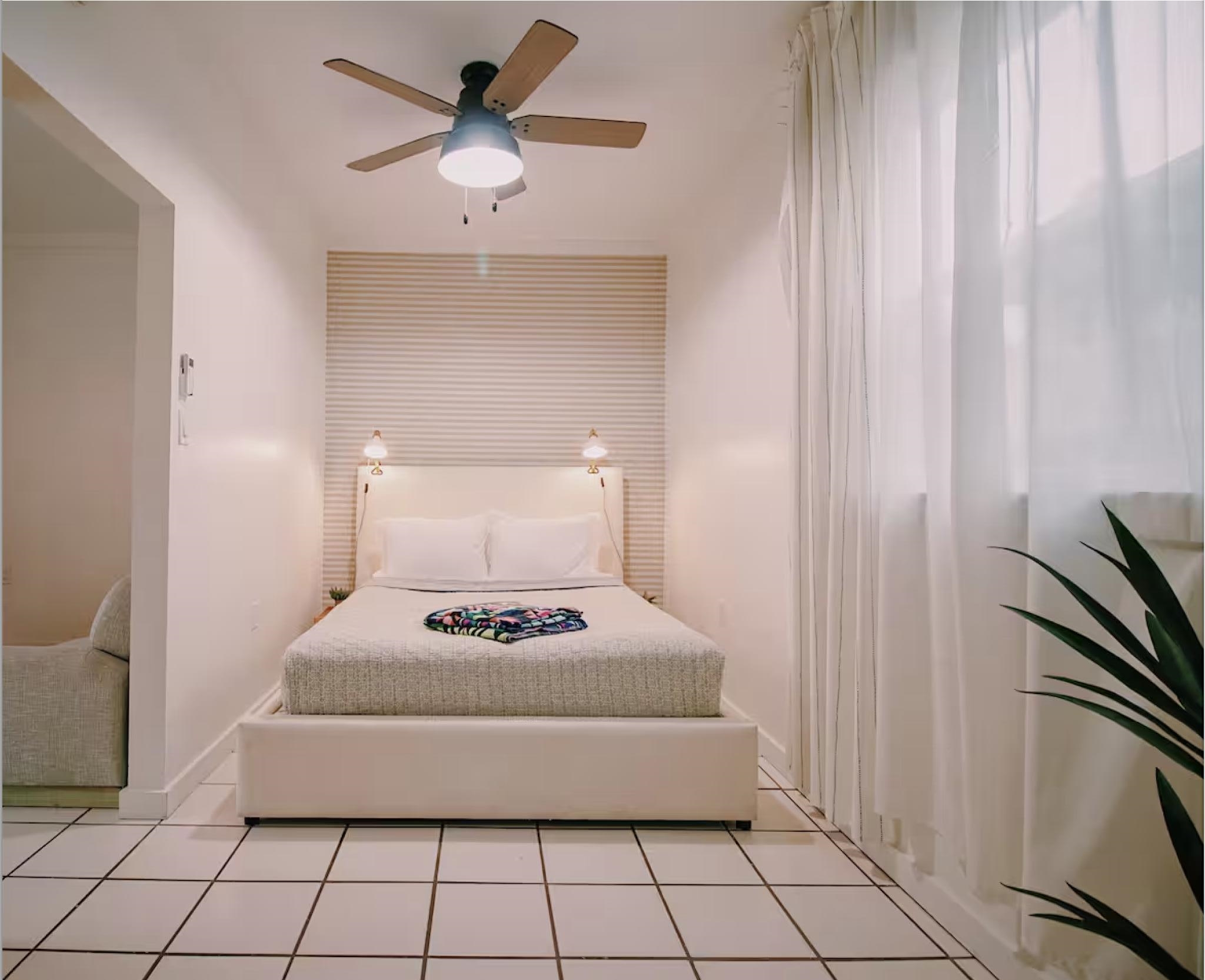 5092 A1A South St. Augustine, FL 32080 - Photo 2 of 14 a bedroom with a bed and a chandelier